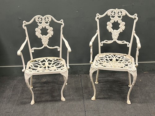 Lot 489 - A pair of cast alloy white painted garden chairs