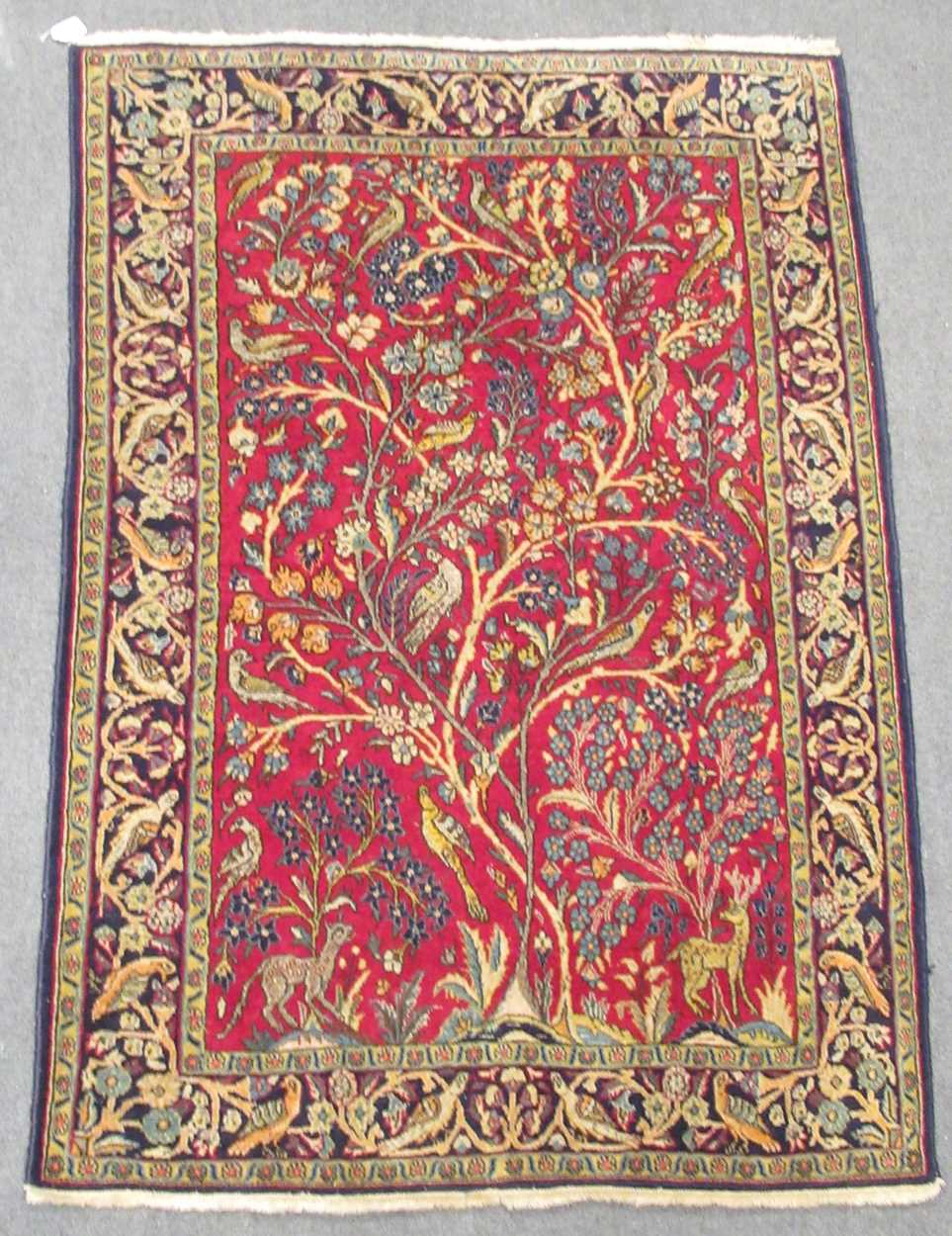Lot 454 - A Tabriz tree of life rug birds and animals on...