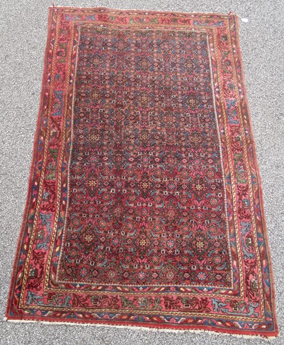Lot 456 - A Ferraghan rug with herati design on a rust...