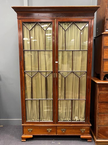 Lot 437 - 19th century glazed mahogany cabinet over two...