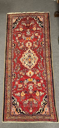 Lot 451 - A Caucasian rug with central medallion on a...
