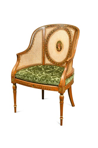 Lot 480 - An Edwardian Sheraton revival painted satinwood and caned bergere armchair