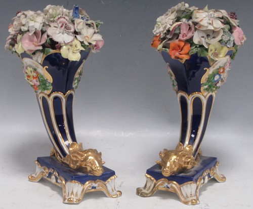 Lot 1 - A pair of Davenport blue and gilt rams head...