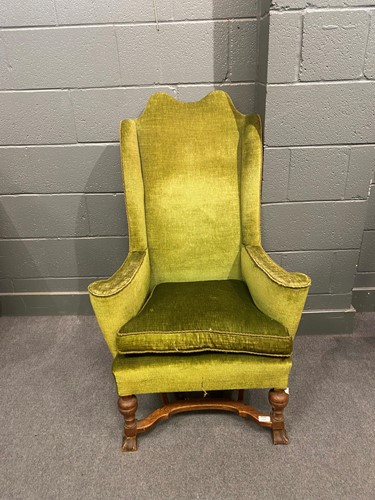 Lot 772 - A Queen Anne style oak wing armchair, green...