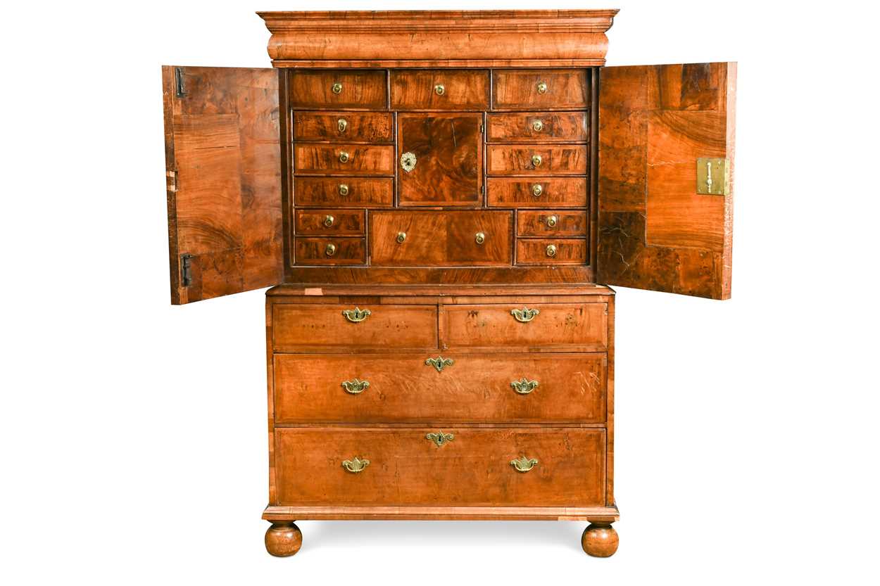 Lot 711 - A William & Mary walnut feather banded cabinet on chest, late 17th century
