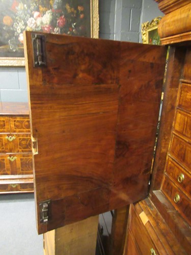 Lot 711 - A William & Mary walnut feather banded cabinet on chest, late 17th century