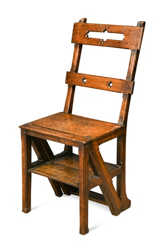 Lot 560 - An Arts and Crafts solid walnut metamorphic library chair