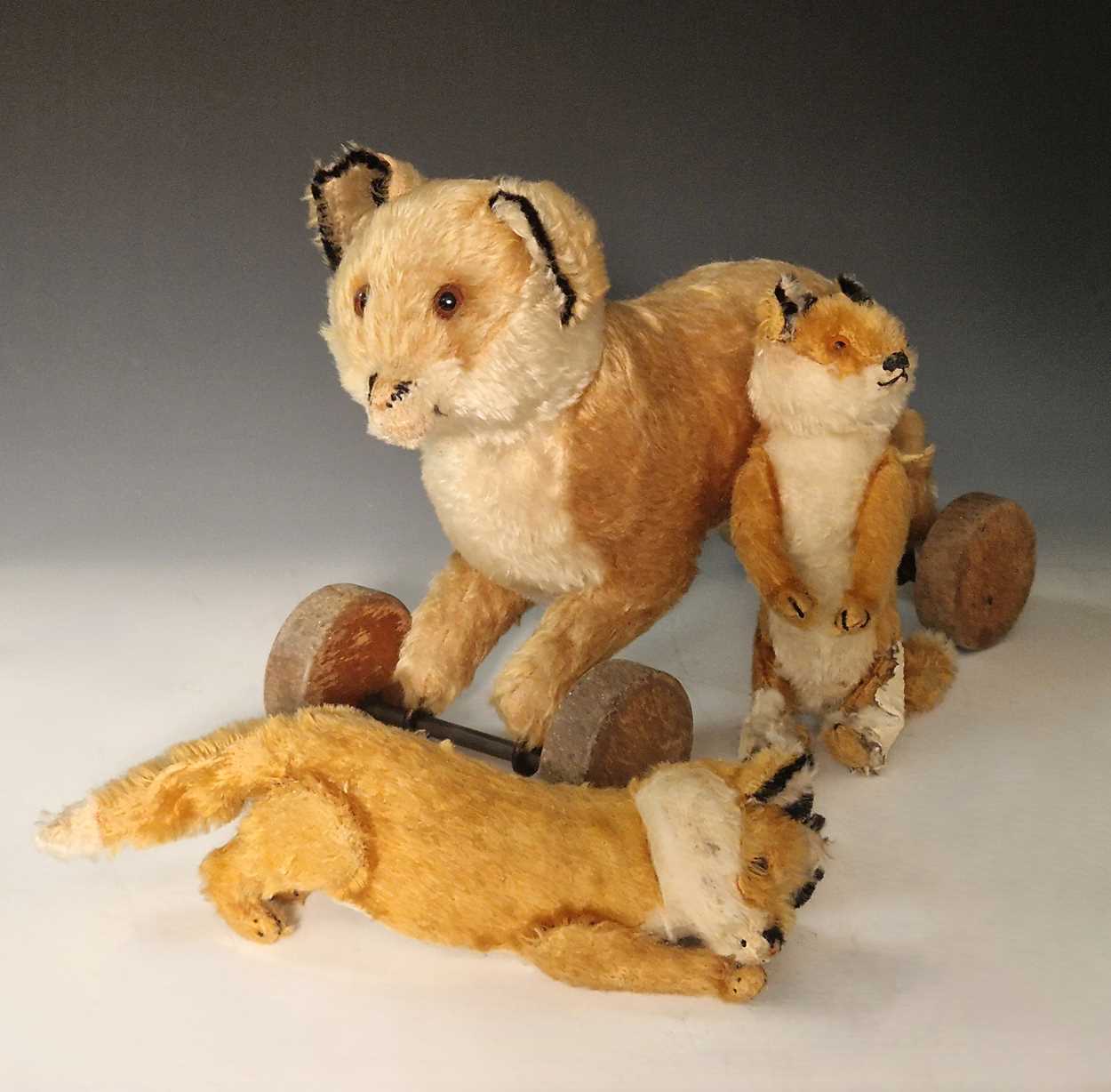 Lot 131 - A vintage Steiff toy fox on wooden wheels