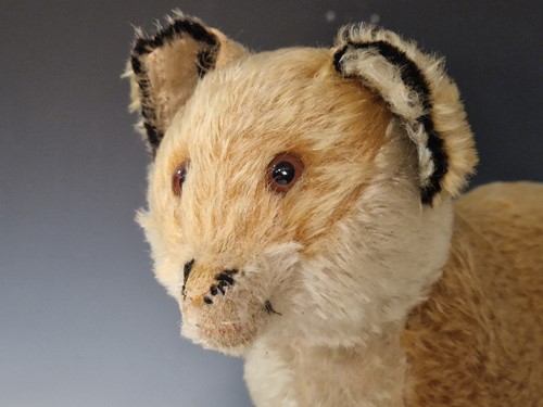 Lot 131 - A vintage Steiff toy fox on wooden wheels
