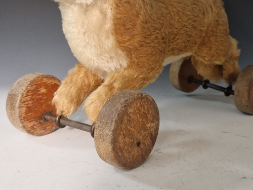 Lot 131 - A vintage Steiff toy fox on wooden wheels
