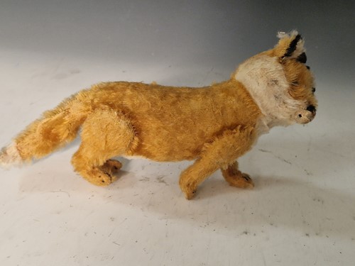 Lot 131 - A vintage Steiff toy fox on wooden wheels