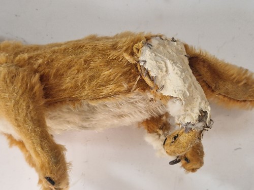 Lot 131 - A vintage Steiff toy fox on wooden wheels