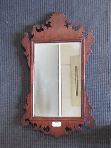 Lot 818 - A small walnut fret framed wall mirror 60 x 34....