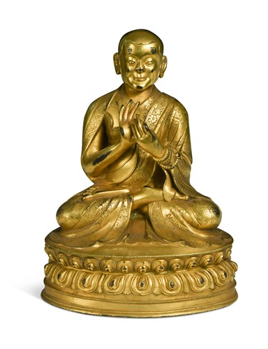 Lot 82 - A Chinese or Tibetan gilt bronze figure of a Lama