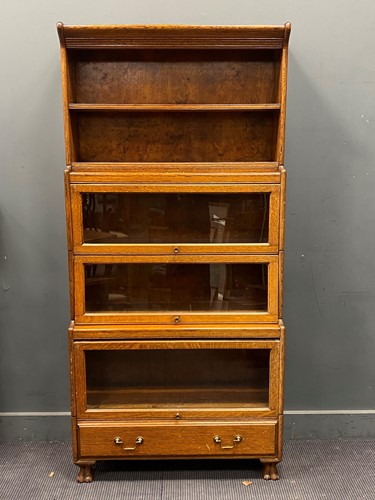 Lot 800 - A early 20th century oak stacking bookcase,...