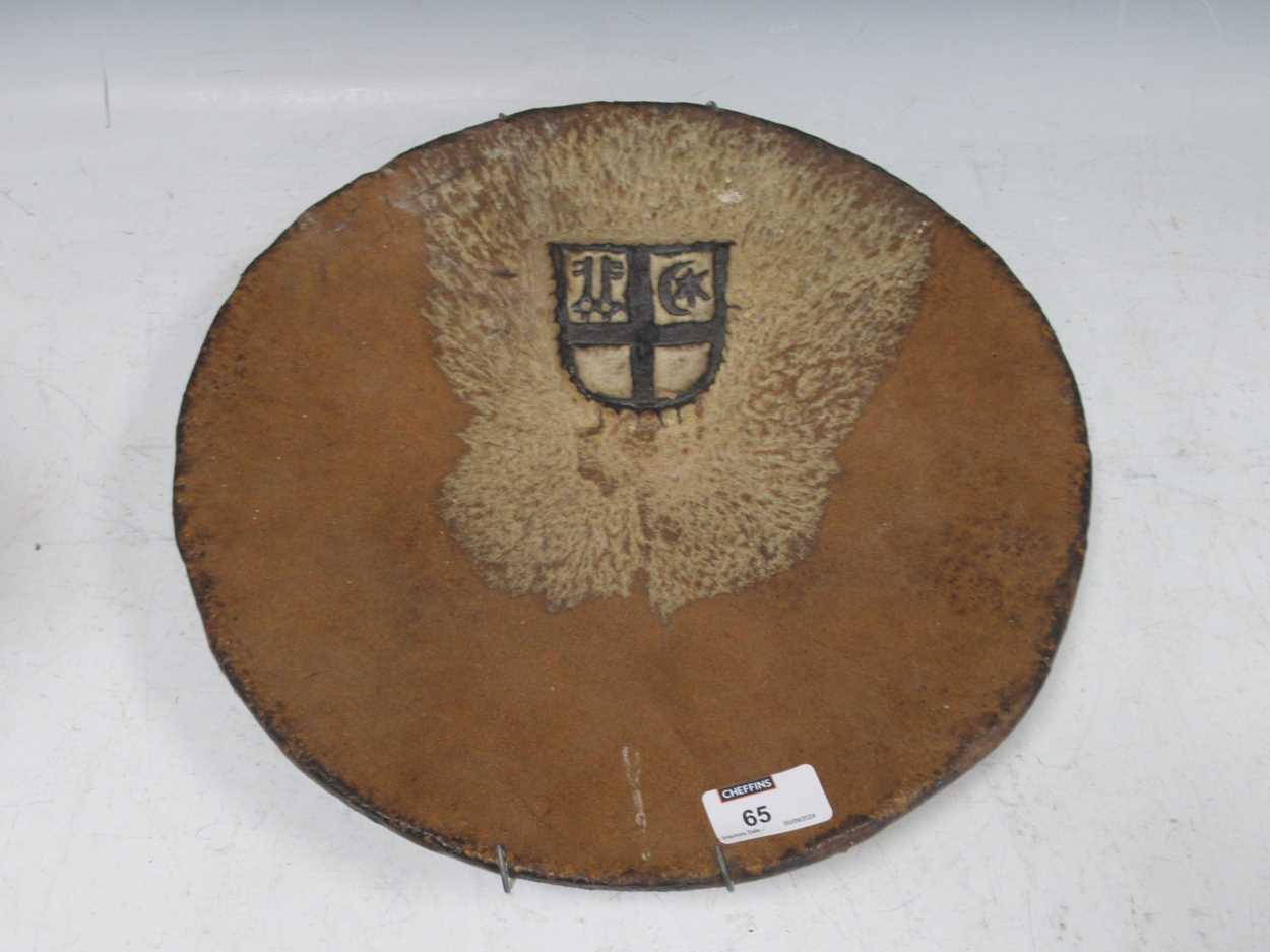 Lot 65 - A stoneware Studio pottery dish with heraldic...