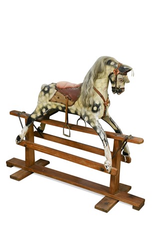 Lot 612 - A carved and painted wooden rocking horse, early 20th century