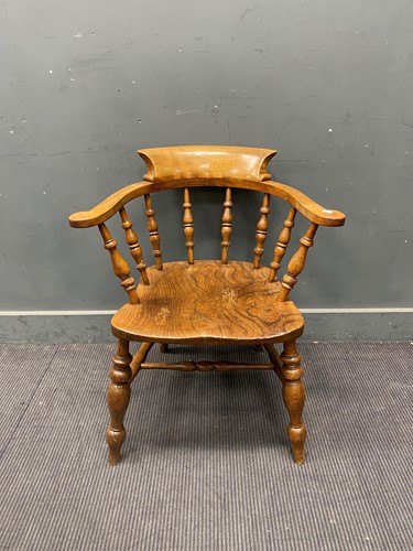 Lot 700 - A 20th century elm smoker's bow armchair 78cm...