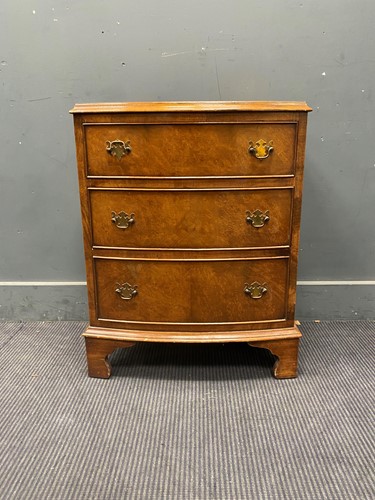Lot 689 - Small walnut bow front chest of three drawers...