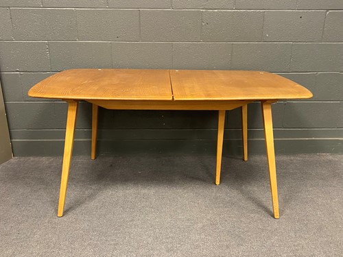 Lot 765 - An Ercol type extending dining table with two...
