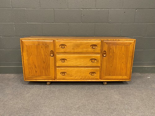 Lot 761 - An Ercol type stained elm sideboard with three...