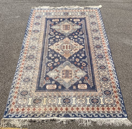 Lot 854 - Three modern rugs blue ground kazakh type...