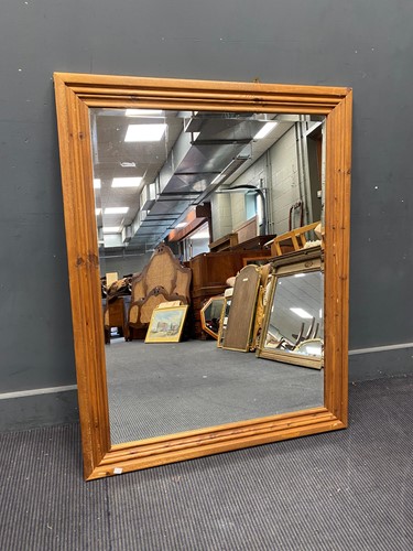 Lot 738 - A moulded pine rectangular wall mirror,...