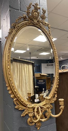 Lot 624 - An oval giltwood wall mirror girandole with...