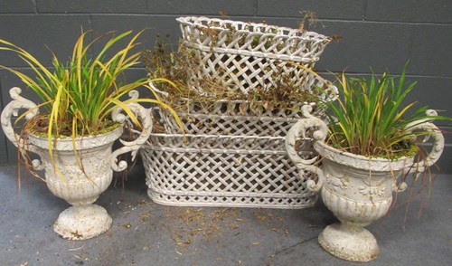 Lot 832 - A pair of white painted cast metal garden urns with scrolled handles
