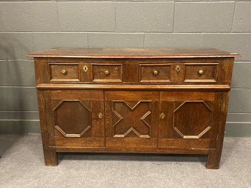 Lot 623 - An 18th century oak dresser base two panelled...