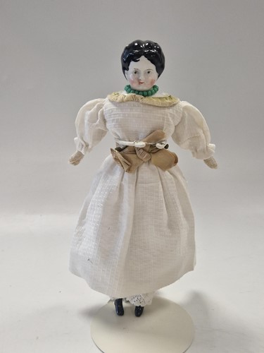 Lot 36 - A group of three German china shoulder head dolls' house dolls, late 19th century