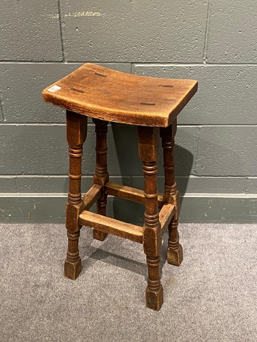 Lot 822 - An oak stool, early 20th century, the shaped...