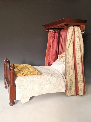 Lot 30 - A Victorian miniature mahogany half-tester dolls' bed