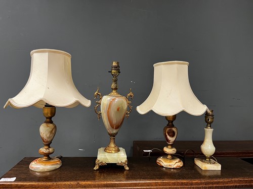 Lot 791 - Four onyx table lamps, 20th century, to...