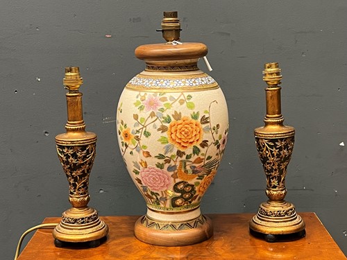 Lot 792 - A pair of black and gilt table lamps of...