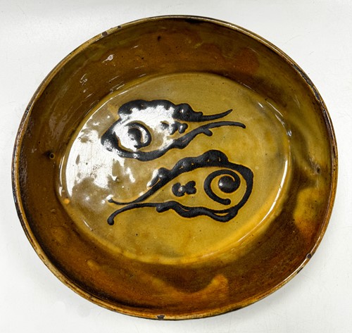 Lot 56 - Charles Tustin (1922-1966) at WInchcombe Pottery, a slipware dish