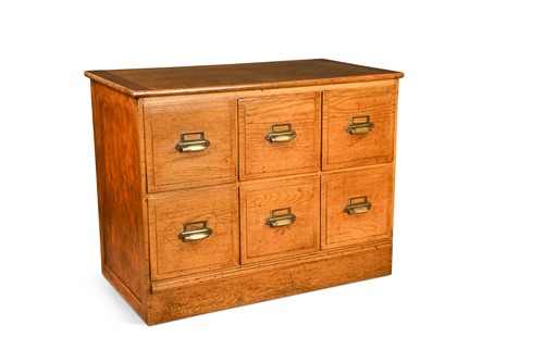 Lot 284 - An early 20th century oak haberdasher's chest