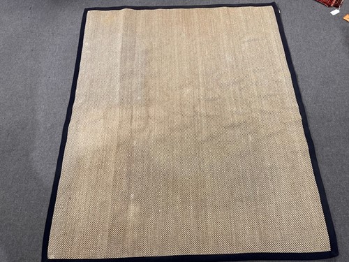 Lot 785 - A large sisal rug with navy contrast bound...