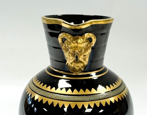 Lot 25 - Attributed to Christopher Dresser for Wedgwood, a jackfield glaze 'Doric' jug
