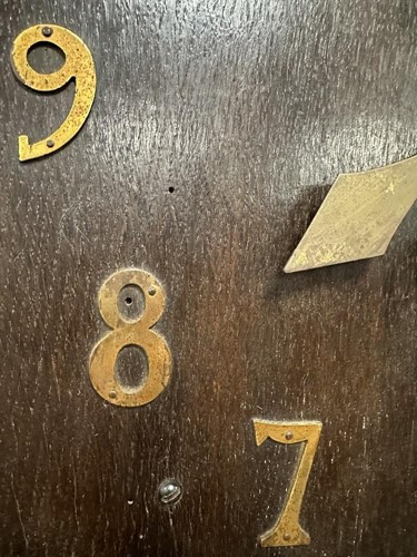 Lot 482 - An Arts & Crafts oak wall clock