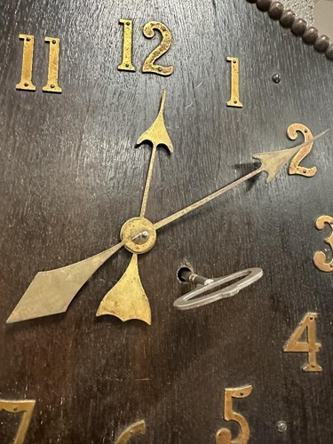 Lot 482 - An Arts & Crafts oak wall clock