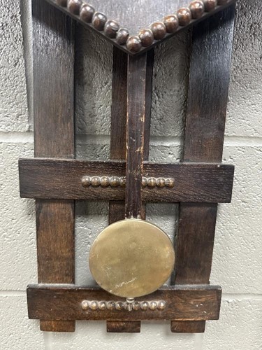 Lot 482 - An Arts & Crafts oak wall clock