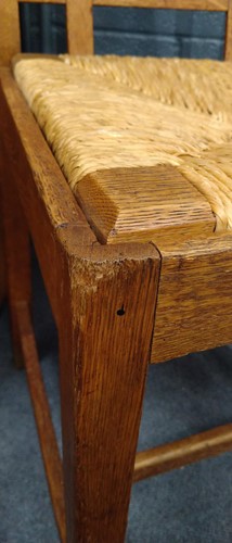 Lot 266 - Paul Matt for Brynmawr Furniture, a set of twelve Arts & Crafts oak 'Mount' dining chairs