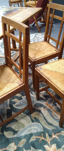 Lot 266 - Paul Matt for Brynmawr Furniture, a set of twelve Arts & Crafts oak 'Mount' dining chairs