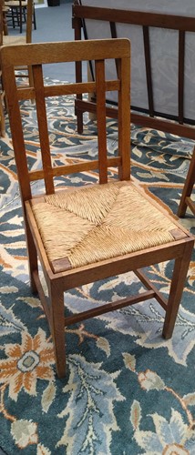 Lot 266 - Paul Matt for Brynmawr Furniture, a set of twelve Arts & Crafts oak 'Mount' dining chairs