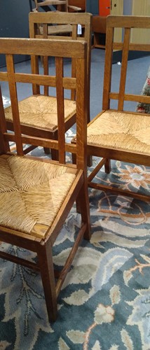 Lot 266 - Paul Matt for Brynmawr Furniture, a set of twelve Arts & Crafts oak 'Mount' dining chairs
