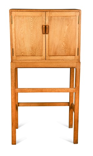 Lot 271 - A Cotswold School oak cabinet on stand