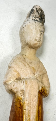 Lot 7 - A group of four Chinese partly straw-glazed pottery lady court attendants, Tang Dynasty