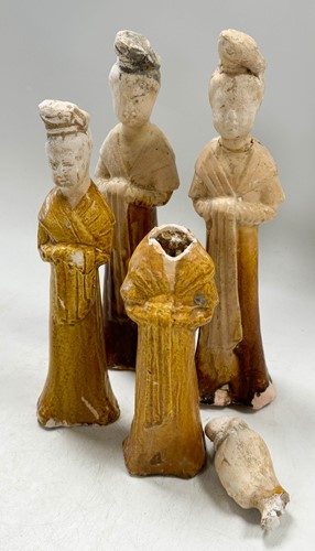 Lot 7 - A group of four Chinese partly straw-glazed pottery lady court attendants, Tang Dynasty