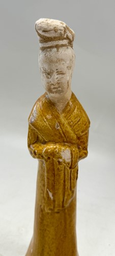 Lot 7 - A group of four Chinese partly straw-glazed pottery lady court attendants, Tang Dynasty